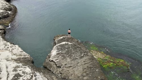 aerial person on rock sea