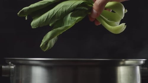 Adding Fresh Bok Choy to a Steaming Pot