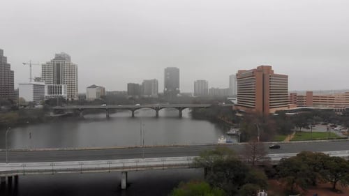 On a misty morning in Austin, Texas, a drone captures traffic crossing bridges over the Colorado Riv