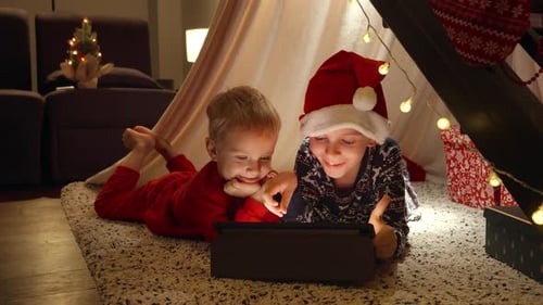 Boys Using Tablet in Christmas Tent at Home