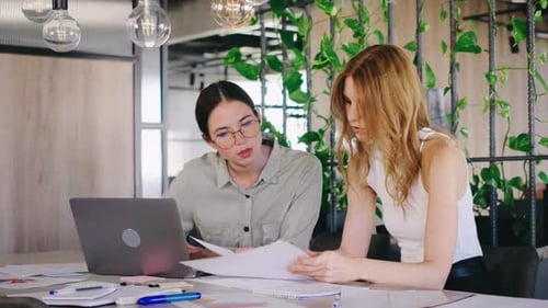 Two Young Women Collaborating on Business Project