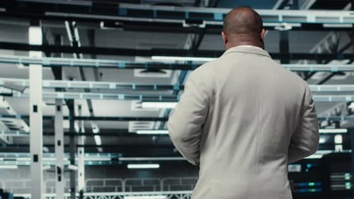 Data Center System Administrator Checks Infrastructure Diagnostics Using Tablet