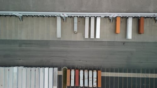 Warehouse with Semi Trucks and Cargo Trailers Aerial Above View