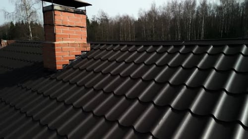 Close Up of a Roof with Chimney Made of Brickwork on House