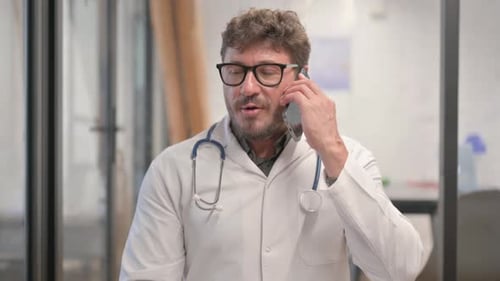 Doctor Using Phone in Hospital Setting