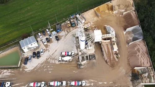 Aerial View of Concrete Production Plant with Mixer Trucks and Silos