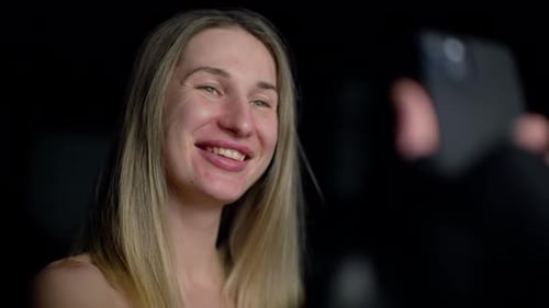 A Girl Blows a Kiss Through Her Phone Communication in the Modern World Communication Via