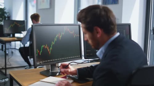 Forex Trader Working Computer Analyzing Graphs at Company Office Space Closeup