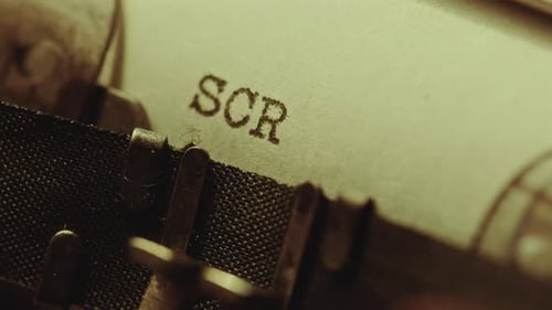 Typing Screenwriting in Upper Case on Paper with Typewriter