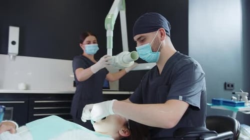 Dentist Preparing Dental X-Ray on Female Patient