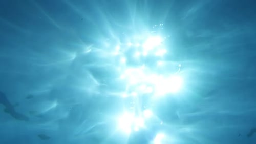 Sun penetrating ocean surface. Underwater god rays vfx background element.