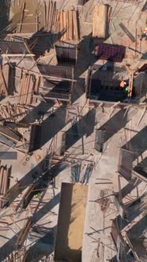 Vertical Video Workers Build Walls on an Active Construction Site Highlighting the Precision Behind