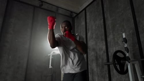 Man Boxing Training Punches in Gym African American Sportive Focused Boxer Fighter Practicing Hits