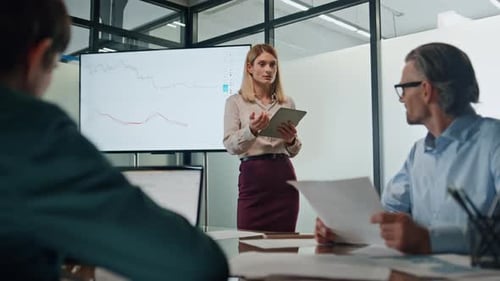 Businesswoman Presenting Data at an Office Meeting