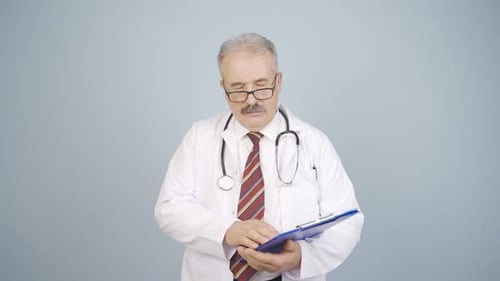 Tired Doctor Rubs Eyes Holding Clipboard
