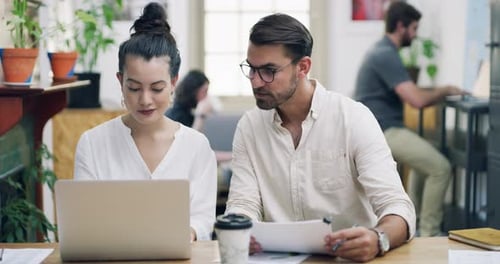 4k video footage of a young businessman and businesswoman having a meeting in a modern office