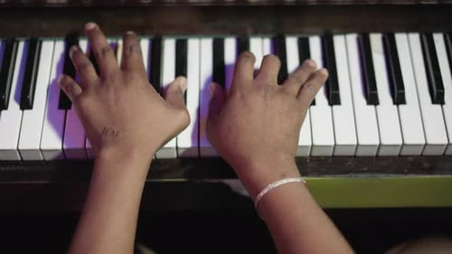 Hands Play Keys on Piano in Close Up Shot