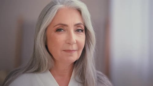 Senior Woman Smiling and Looking at Camera