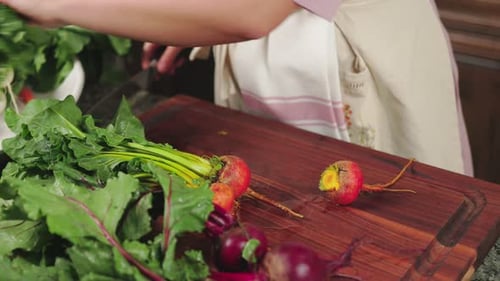 Woman Cutting Fresh Beets in a Kitchen