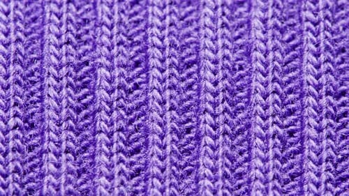 Knitted Warm Purple Sweater or Scarf Macro Close Up Texture Cozy Warm Composition of Wool Fabric