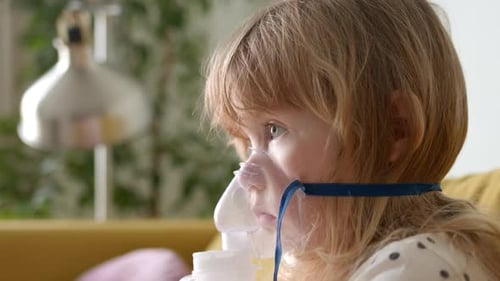Close View of Cute Child Girl Toddler in Medical Mask Steam is Coming Child is Treated for Cough at