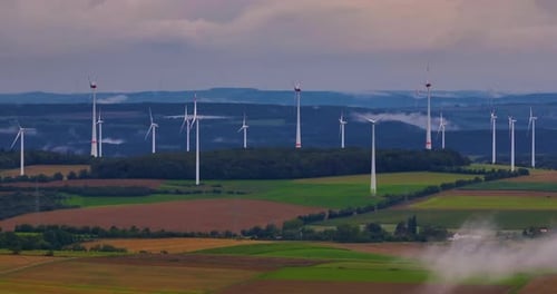 Aerial View of Powerful Wind Turbine Farm for Energy Production on Beautiful Cloudy Sky at