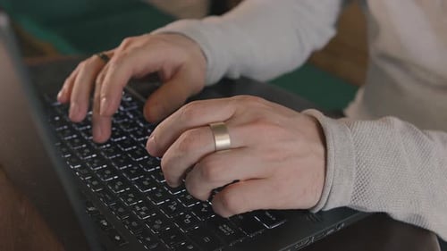 Close Up of Freelancer's Developer Hands Typing Program Code on Laptop Keyboard in Coworking