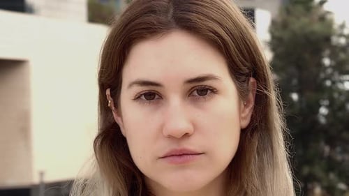 Portrait of Blonde Young Woman Looking at Camera Seriously in a City Spanish Woman