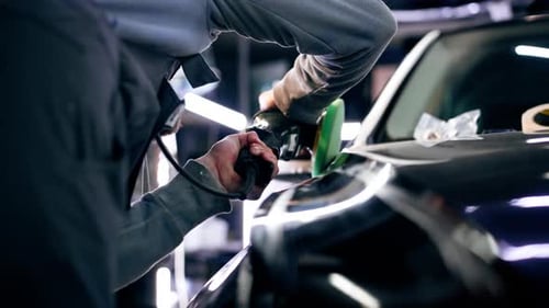 the Car Mechanic at a Service Station Doing the Final Polishing to Shine
