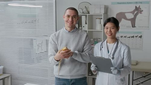 Man Holds Lizard at Vet Clinic With Doctor