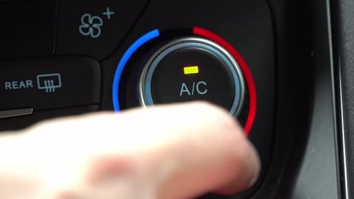 Turning on car climate control button in automatic mode of temperature control in cabin