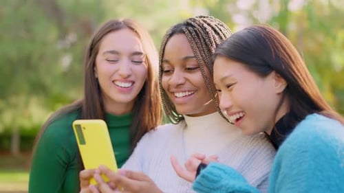 Smiley Multiethnic Friends Having Fun Using the Mobile Outdoors