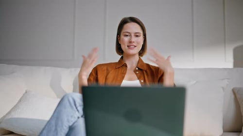 Young Woman Communicating Via Laptop Video Call