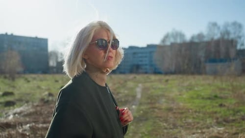 Stylish Woman Walking Outdoors on Sunny Day