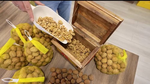 Pouring Shelled Walnuts into Wooden Box