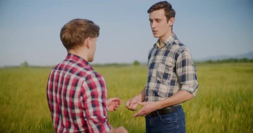 Two Male Farmers Discussing In Field Agriculture Crops Business Talking