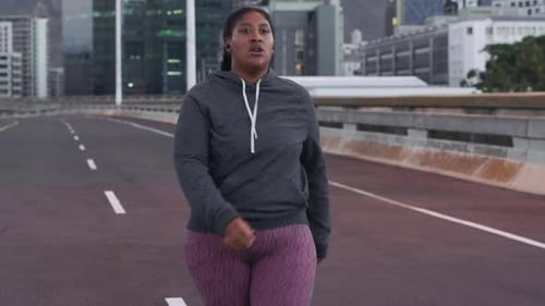 Young Woman Walks on Road Towards Camera