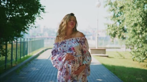 Expecting Joy During a Sunny Stroll in a Beautiful Park