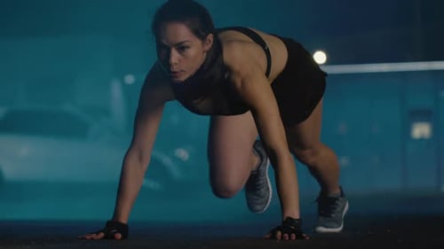 Beautiful Energetic Fitness Girl in Black Athletic Top and Shorts is Doing Mountain Climber Exercis