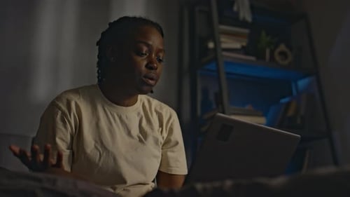 Sleep-Deprived Woman Ending Online Session with Psychologist in Bed