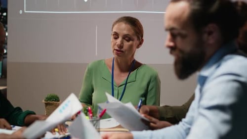 Diverse Team Collaborates at Night in Urban Office