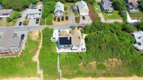 Aerial View of Beachfront Homes on Sunny Day
