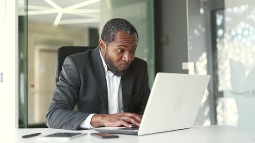 Excited Businessman Celebrates Great News at Office