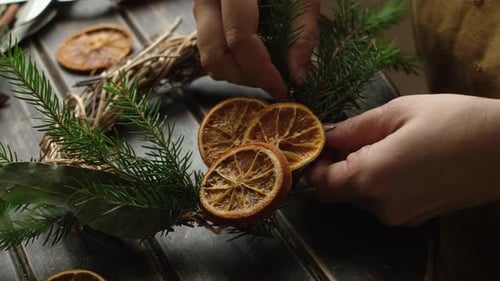 Creating Holiday Wreath with Dried Oranges and Pine