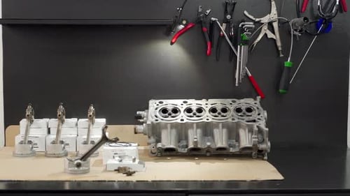 Auto Mechanic Assembles Engine with New Cylinder Head Pistons Rings in Workshop Detailed Car Engine