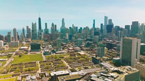Wonderful green city panorama on warm sunny day. Low buildings at the backdrop of amazing skyscraper
