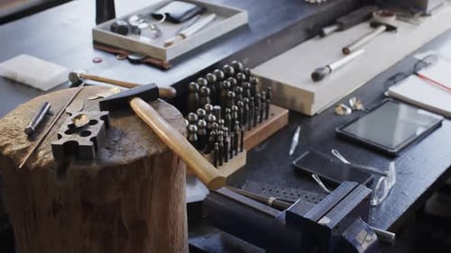 Close up of handcraft tools lying on tree trunk in studio in slow motion