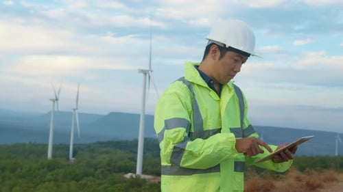 a man engineer is wearing a protective helmet