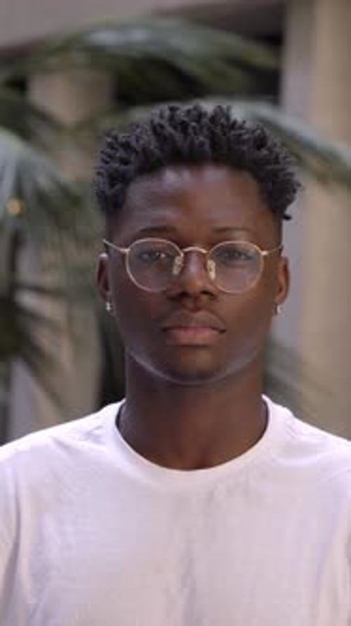 Vertical Video of Serious Black Man Concentrating and Looking at Camera