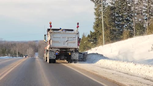 Snowplow truck removing snow on the highway after snowstorm, Ontario, Canada, 2023